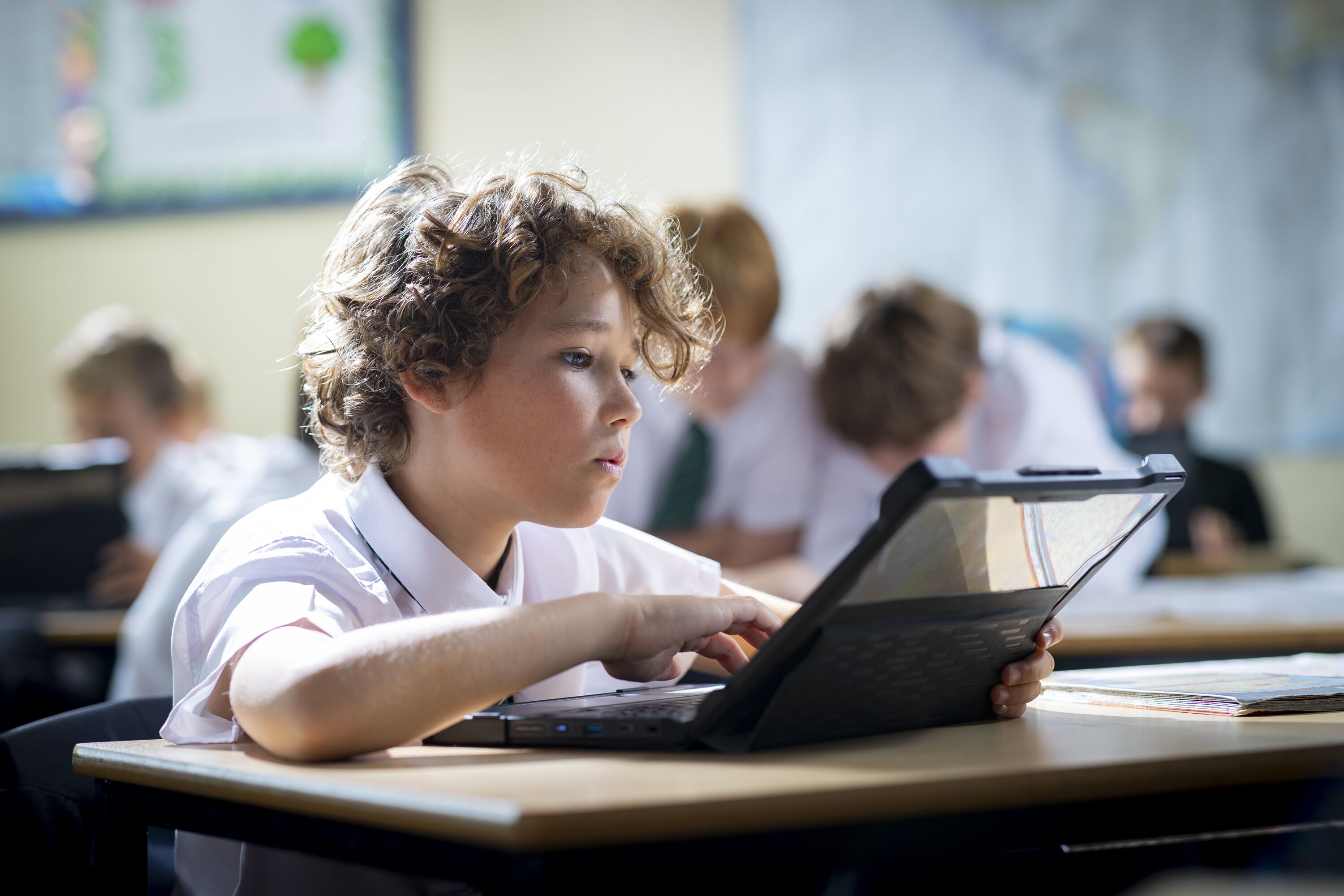 coombe boy working on chromebook